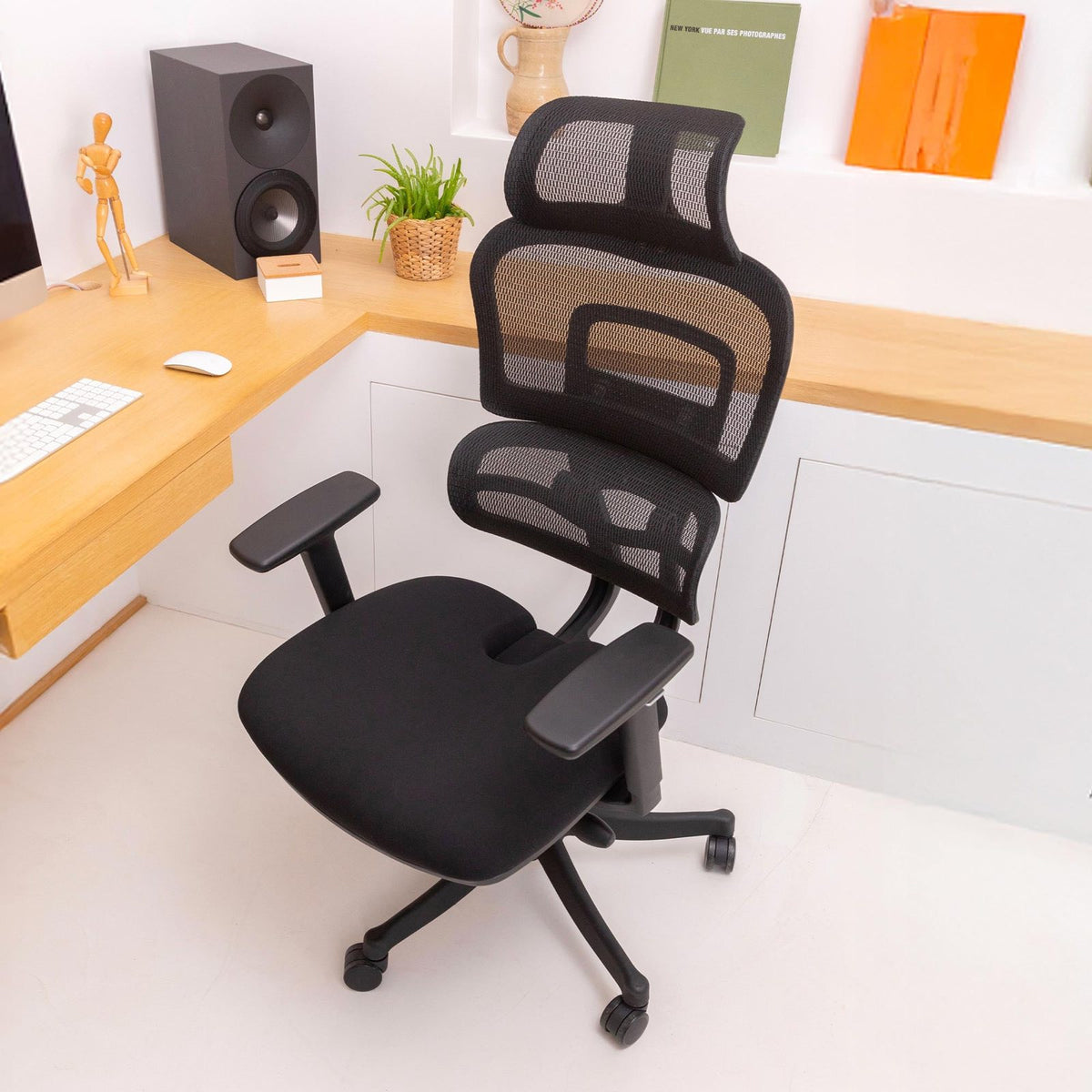 Percko's ergonomic chair in a bright home office, with a supportive mesh back and contoured seat cushion